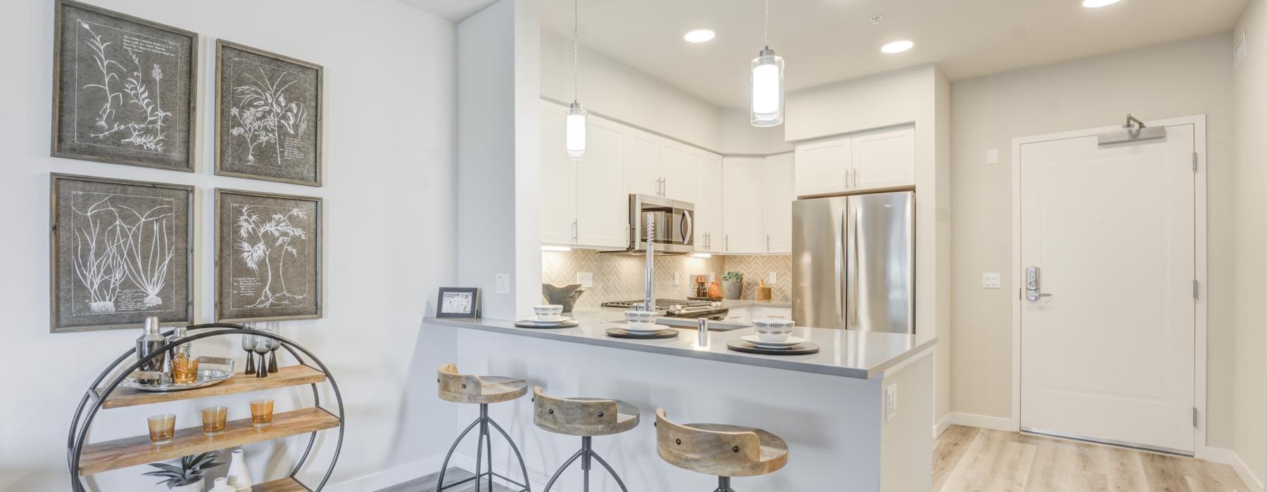 a kitchen with stools and a table