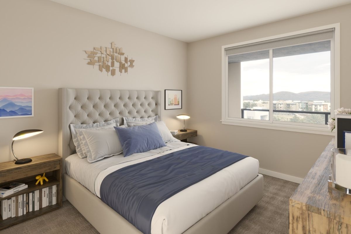 Stylish apartment bedroom with modern headbord, night tables and a window with a view to the streets of Chula Vista.