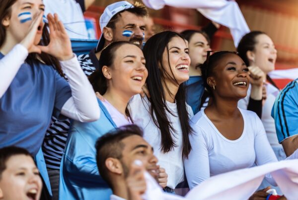 sport fans cheering at a game in stadium